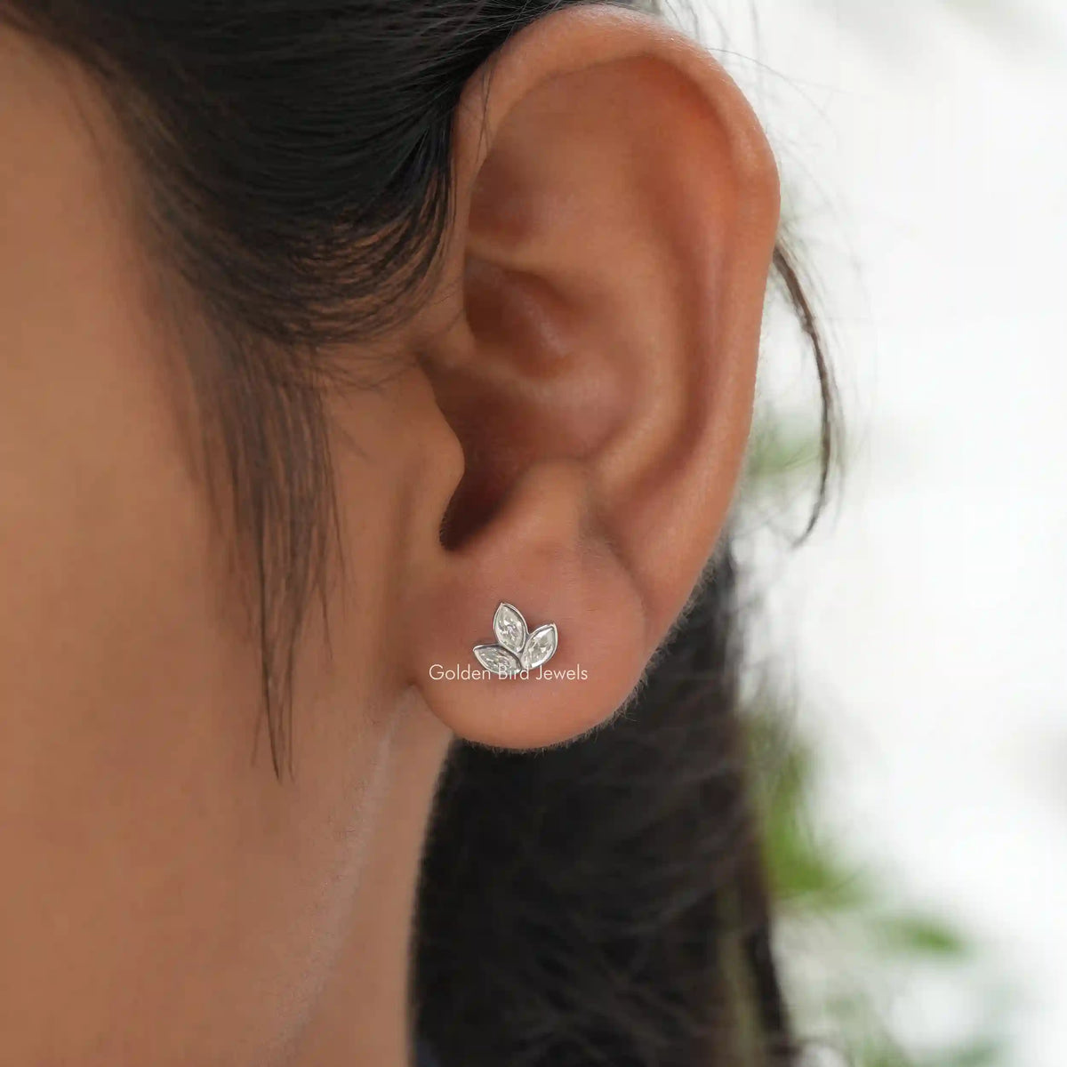 In ear View of colorless marquise cut leaf stud earrings in  colorless moissanite