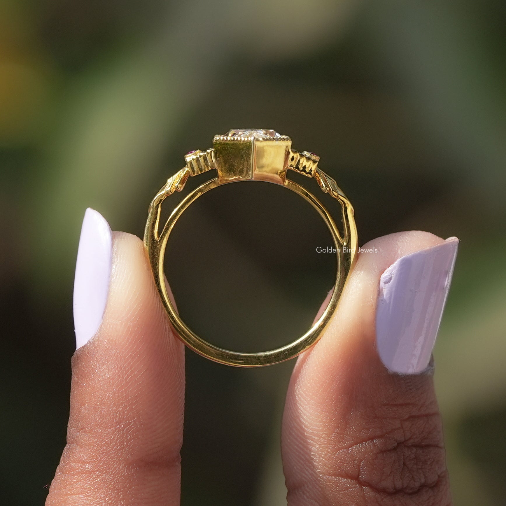 [In two finger front view of moissanite marquise cut ring made of 14k yellow gold]-[Golden Bird Jewels]