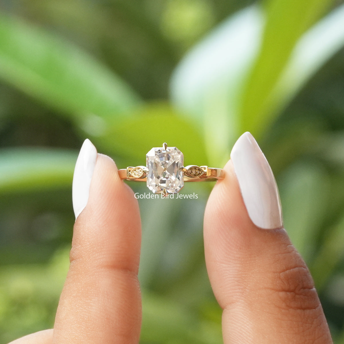 [In two finger front view of moissanite old mine radiant cut engagement ring made of prong setting]-[Golden Bird Jewels]