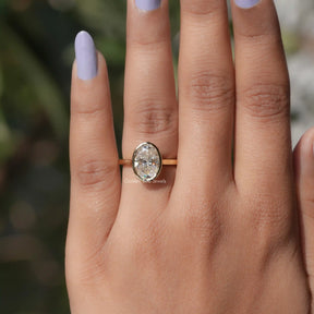 View of Bezel Set Oval Cut Moissanite Ring In Yellow Gold