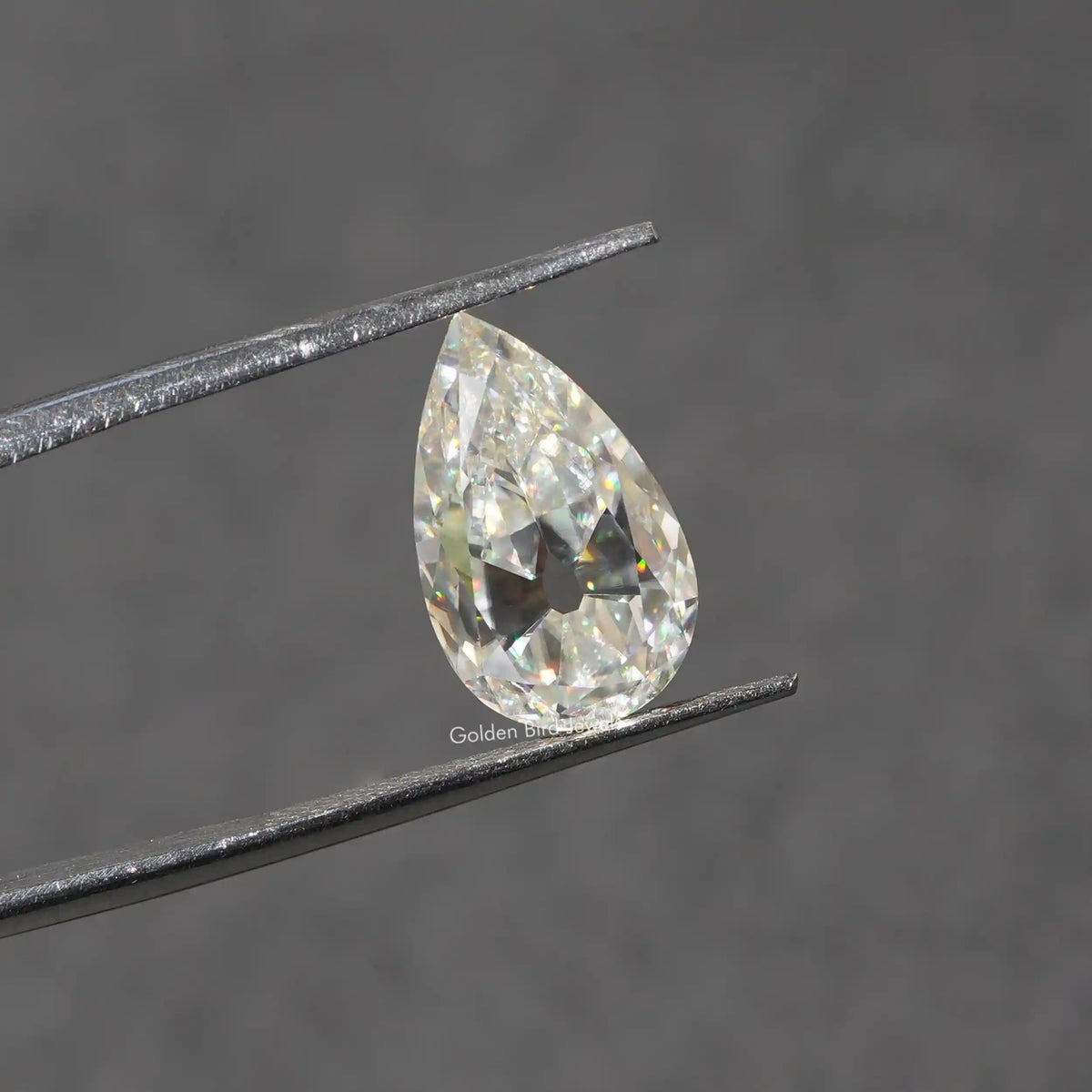 In Tweezer View Of Moissanite Old Mine Pear Cut Loose Stone
