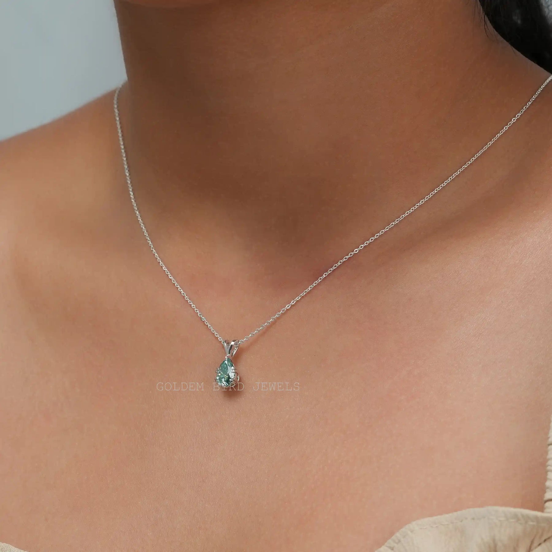 [In neck front view of moissanite blue pear cut pendant in 14k white gold]-[Golden Bird Jewels]
