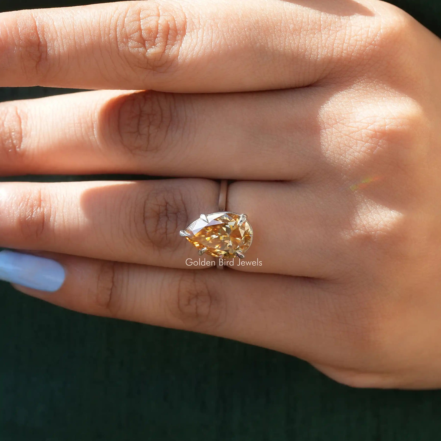 [In Finger side view of moissanite pear cut solitaire wedding ring made of 14k yellow gold]-[Golden Bird  Jewels]