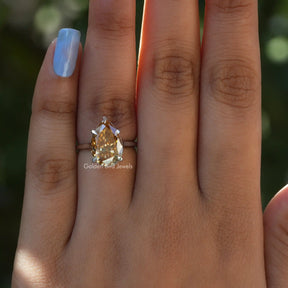 [In finger front view of pear cut solitaire wedding ring set in prongs]-[Golden Bird  Jewels]