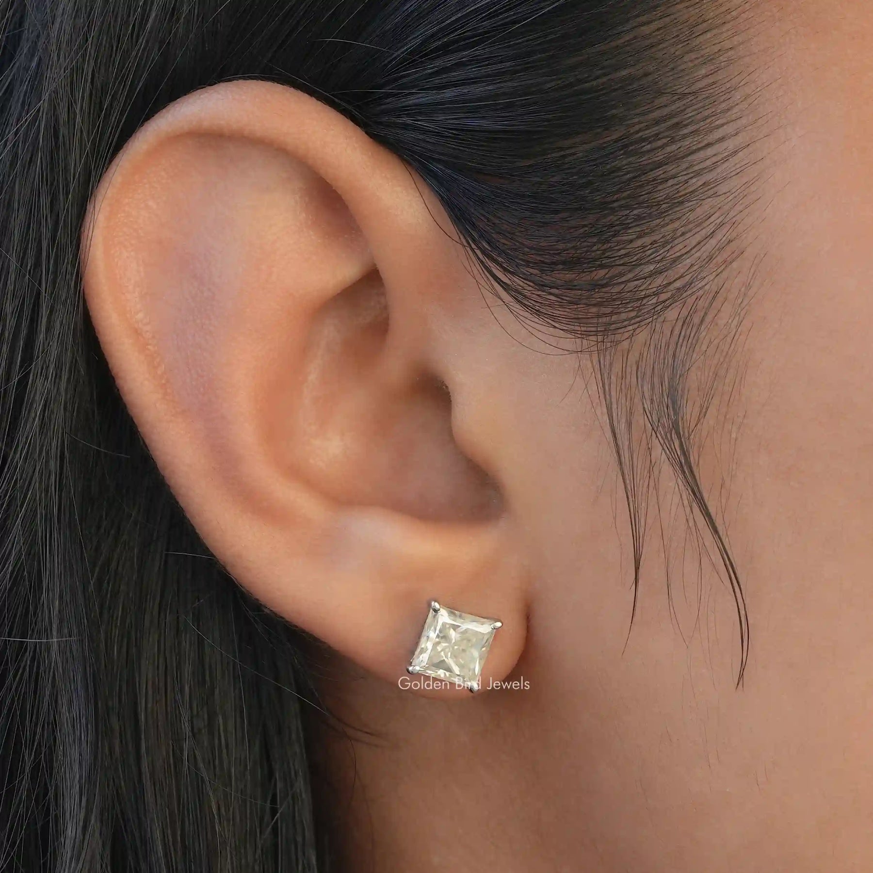 [In ear front view of princess cut stud earrings made of white gold]-[Golden Bird Jewels]