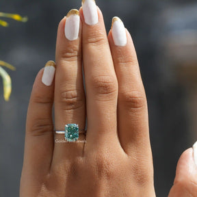 [In finger front view of blue radiant cut solitaire cut engagement ring in 14k white gold]-[Golden Bird Jewels]