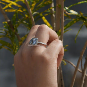 [In finger side view of pear and radiant cut moissanite two stone ring at golden bird jewels]