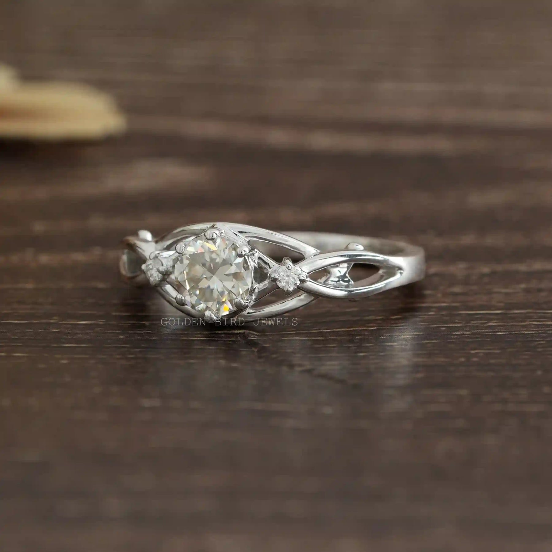 [Side view of round cut moissanite engagement ring set in 14k white gold]-[Golden Bird Jewels]