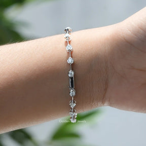 In hand front view of round cut moissanite distance bracelet in secure setting 