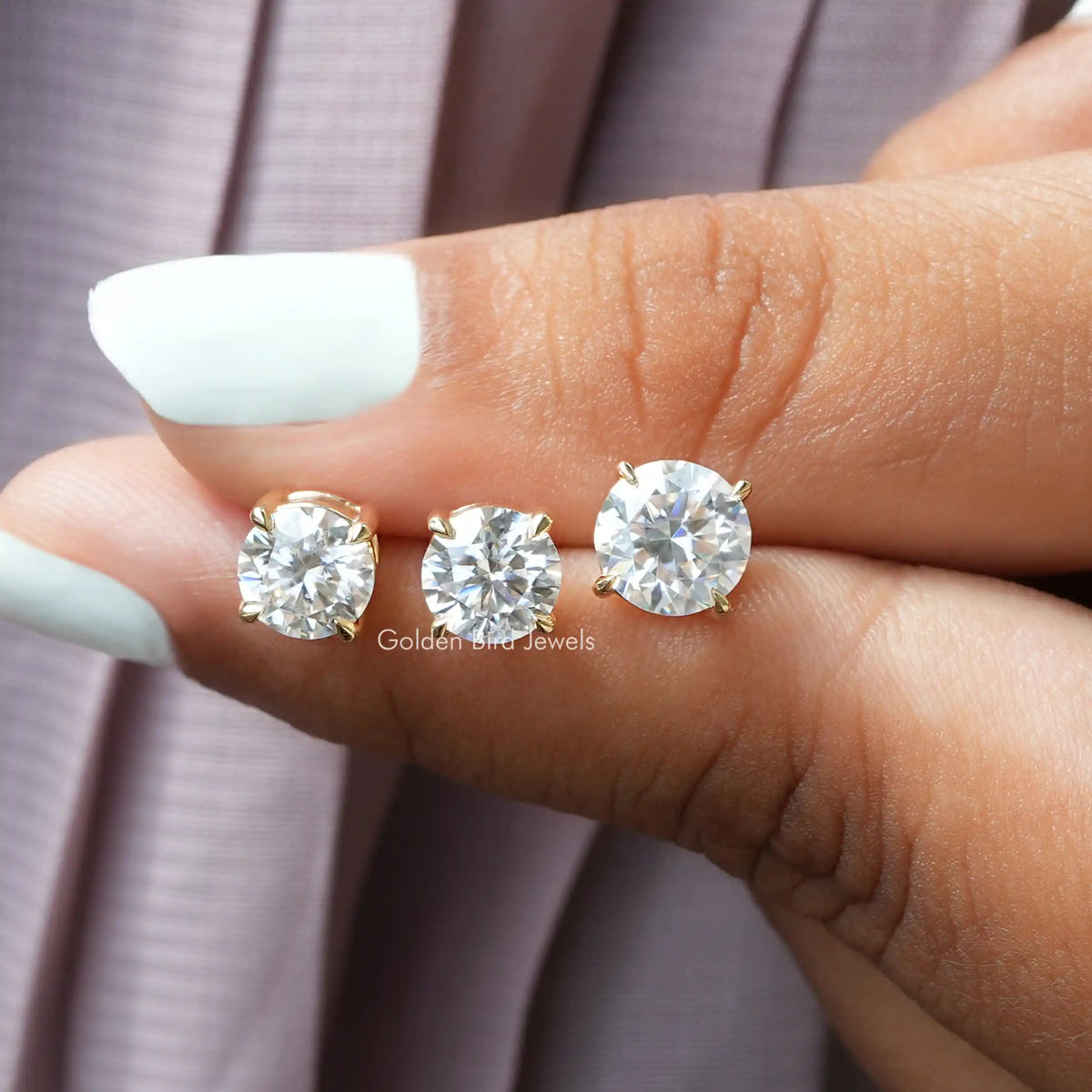 In  two-finger view of Moissamite stud earings 