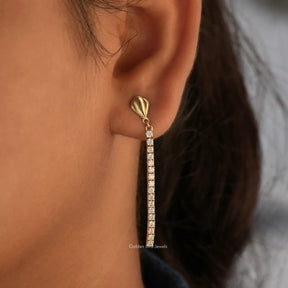 [In ear front view of round cut moissanite drop earrings in 14k yellow gold]-[Golden Bird Jewels]