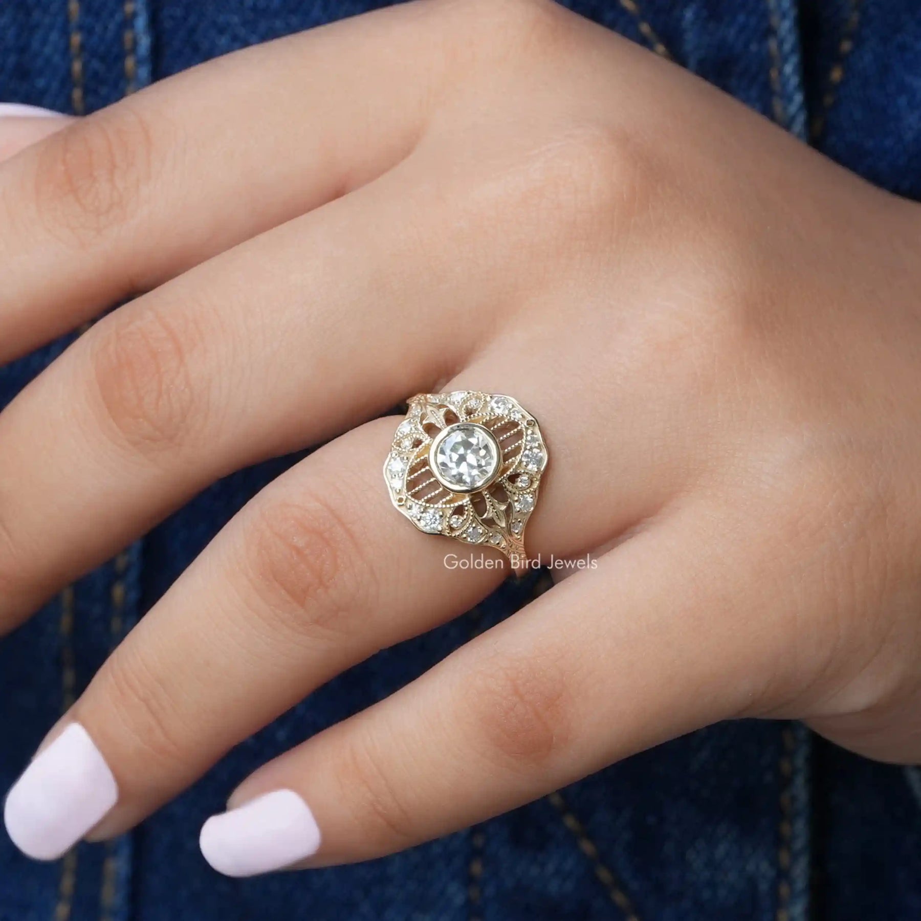 [In finger front view of moissanite round cut vintage style ring in 14k yellow gold]-[Golden Bird Jewels]