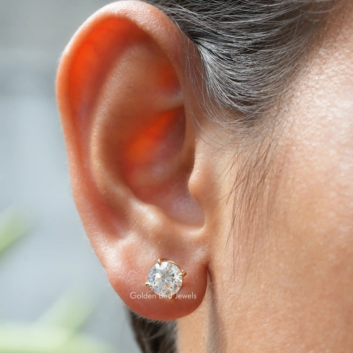 In ear view of Solitaire Round Cut Stud Earrings
