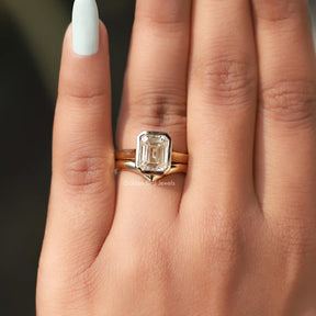 View of Emerald Cut Bezel Set Moissanite Ring In Yellow Gold