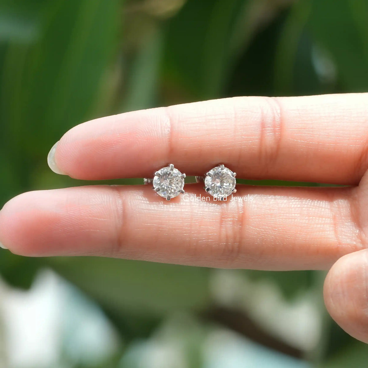 Holding In Finger a Pair of 2.15 TCW Portuguese Moissanite Stud Earrings