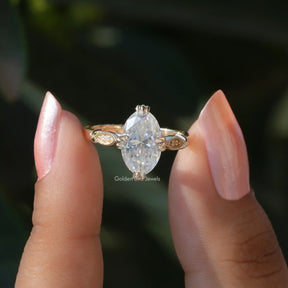 Two fingers holding the Moval Cut Moissanite Engagement Ring