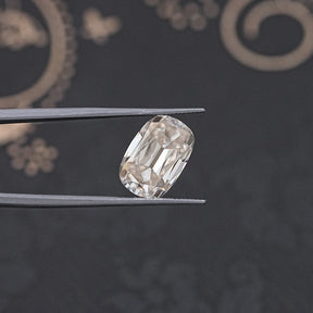 tweezers  View of Cushion Old Cut Moissanite Stone for Anniversary Rings