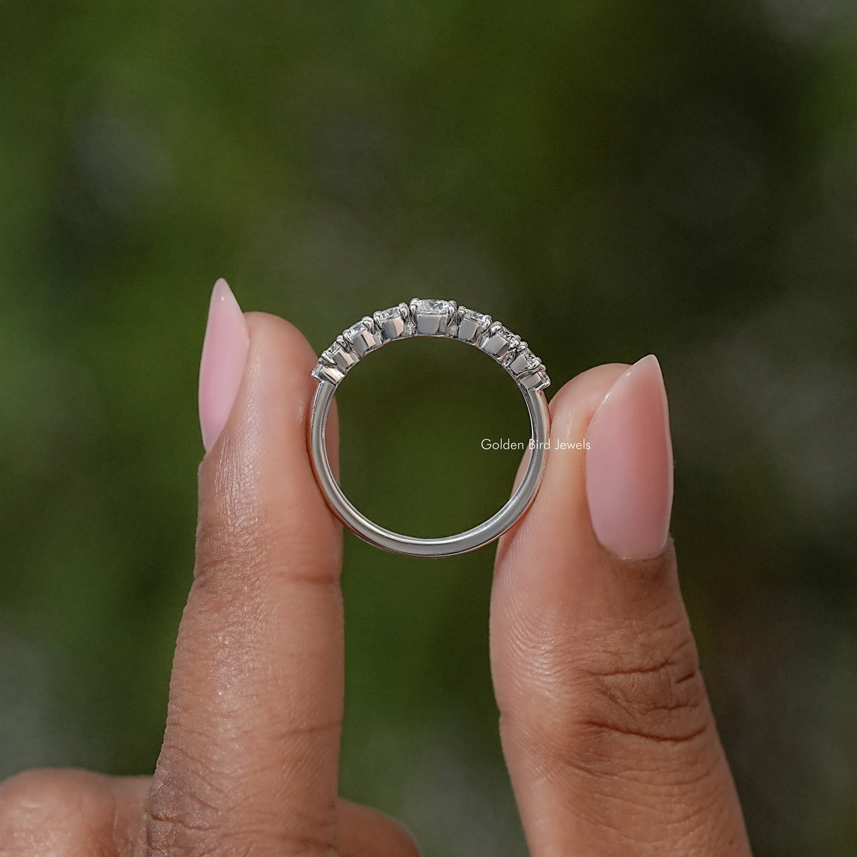 Silver-toned moissanite engagement ring with round stones, top view