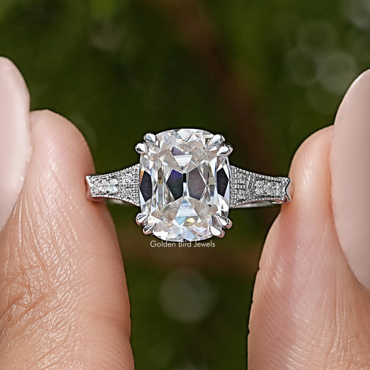 Vintage solitaire ring with elongated cushion-cut clear stone and pavé band