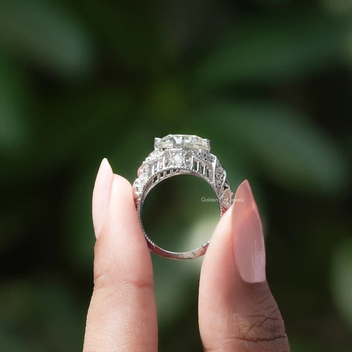 Back View of Old European Round Cut Moissanite Ring In two fingers