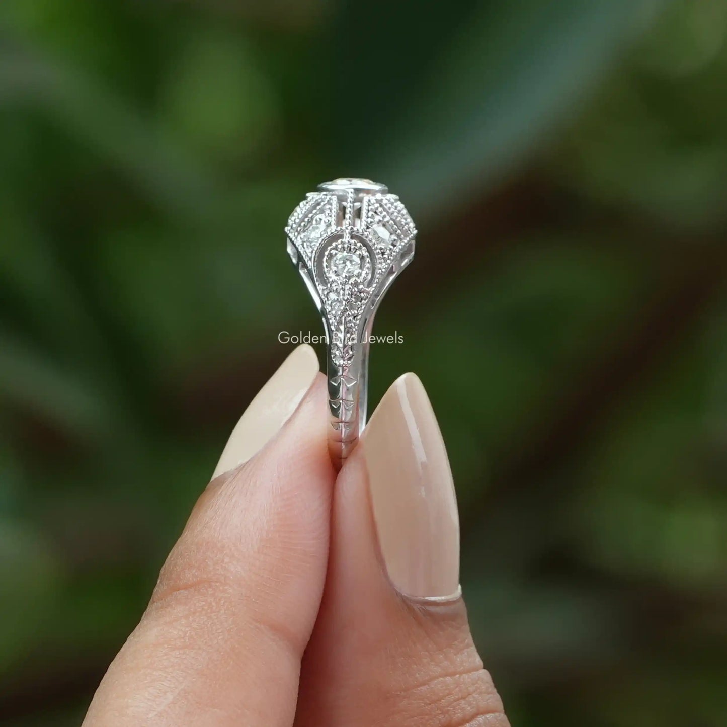 Side View of Round Cut Moissanite Vintage Ring In two fingers