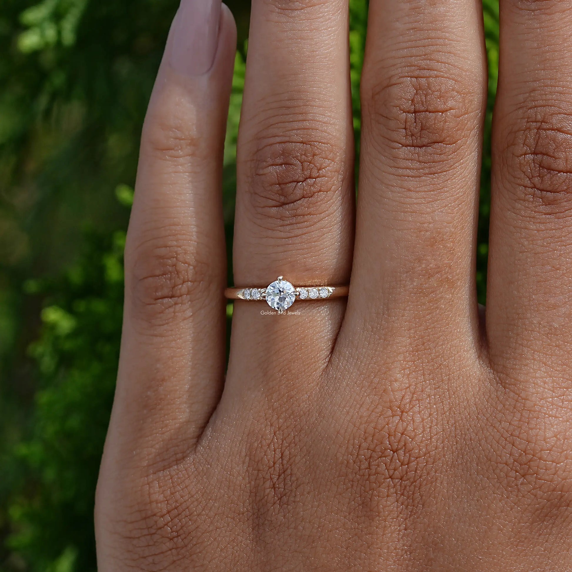 Close-Up View of Round Cut Lab Diamond Accent Ring In two fingers