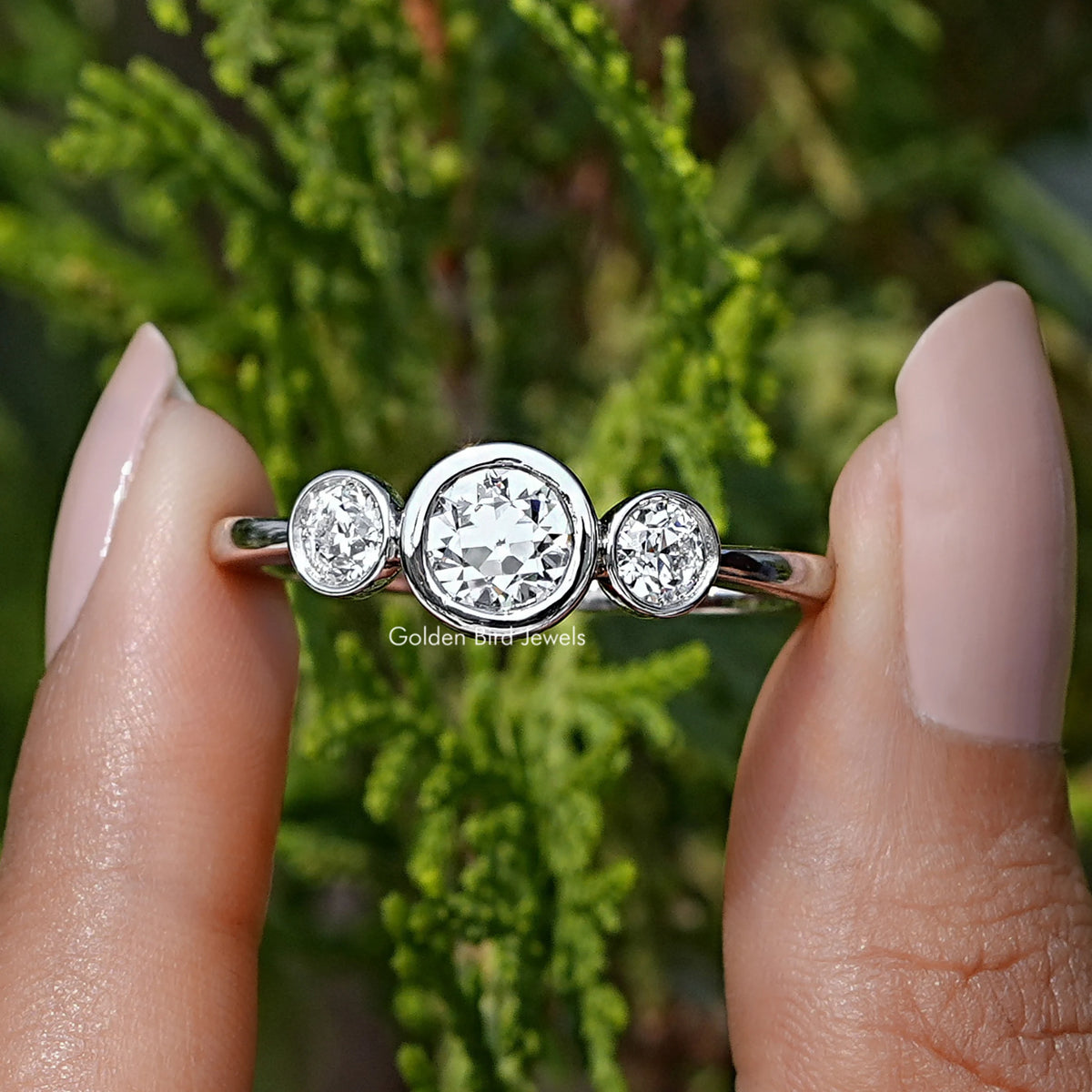 Front View of Old European Round Cut Diamond Three Stone Ring In two Fingers