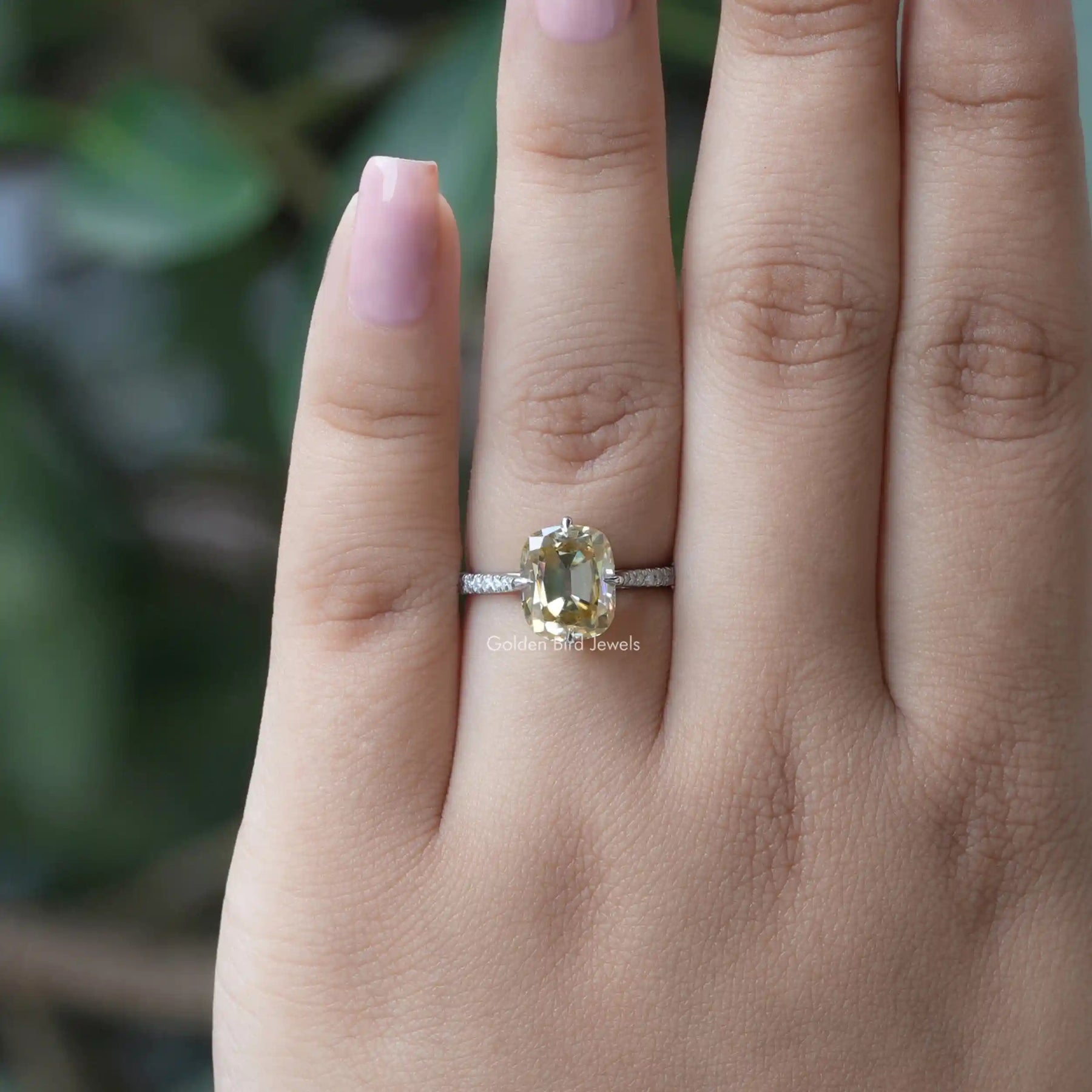 [In finger front view of yellow cushion cut and round cut moissanite]-[Golden Bird Jewels]