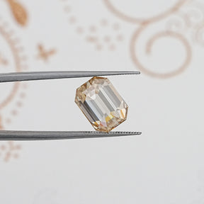 In Tweezer View Of Old Mine Emerald Cut Loose Moissanite Stone
