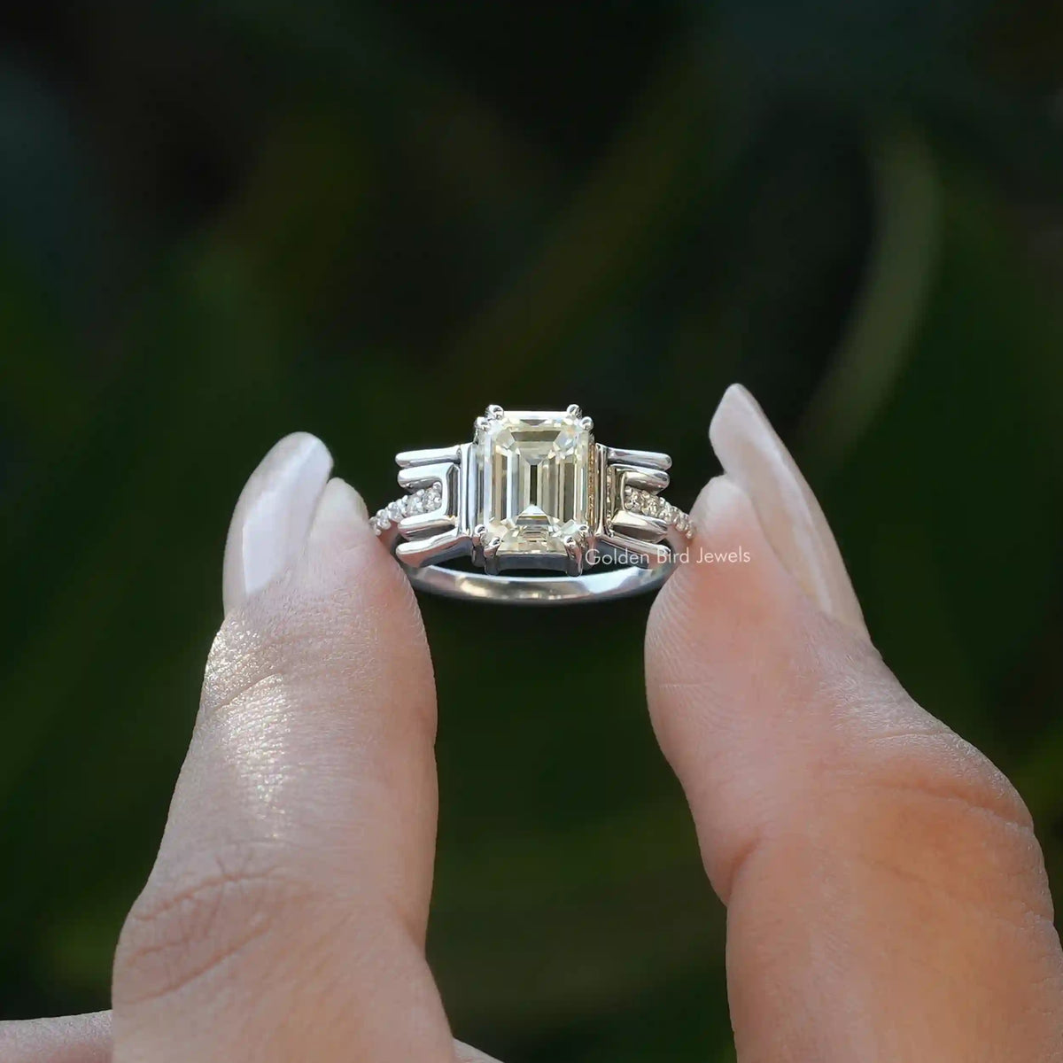 [Emerald cut moissanite engagement ring set in double prong setting]