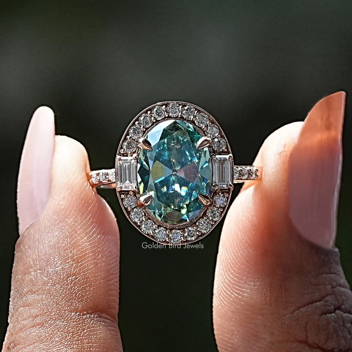 Two fingers holding the Old Mine Oval Cut Moissanite Halo Ring 