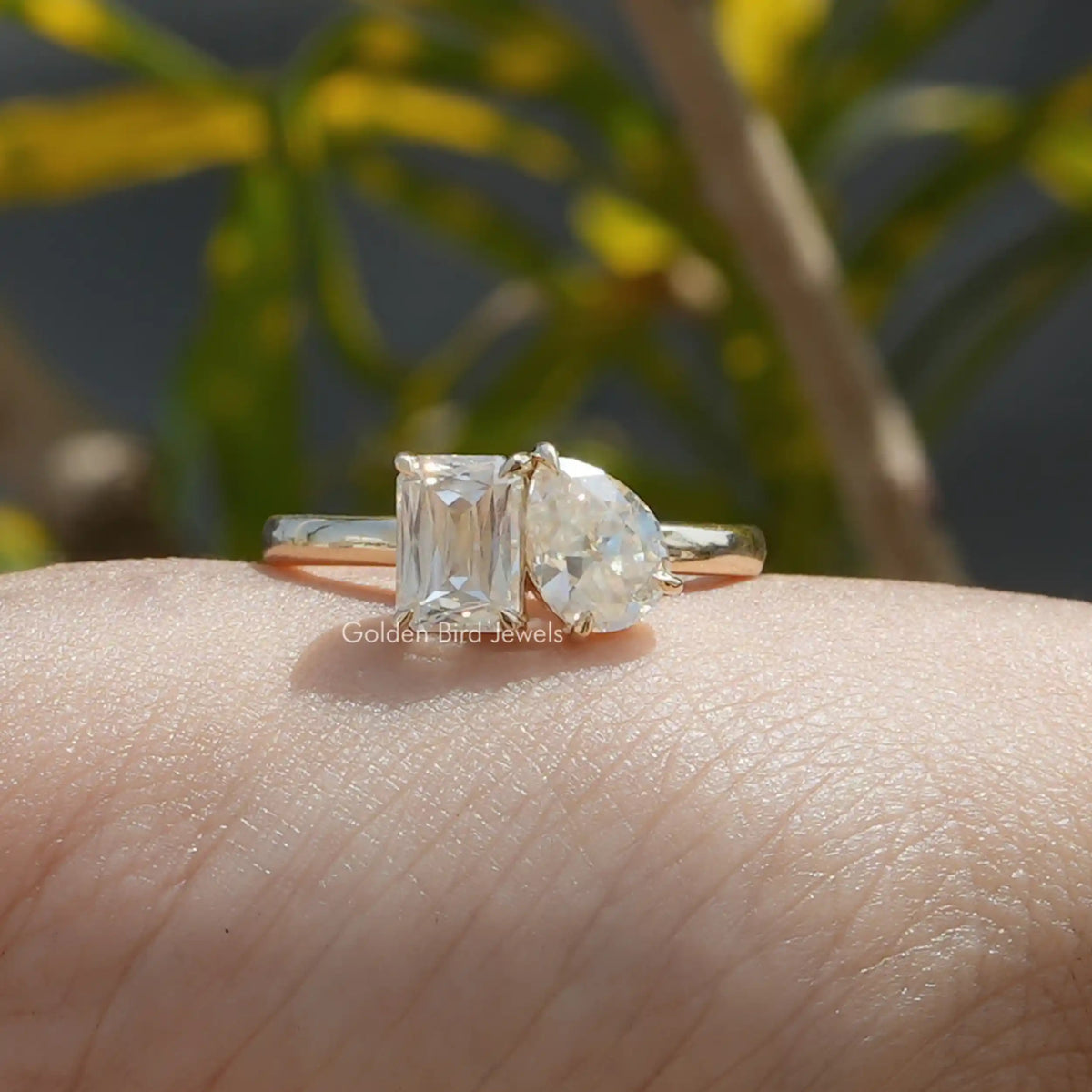 Front view of old mine pear and criss cut moissanite two stone ring