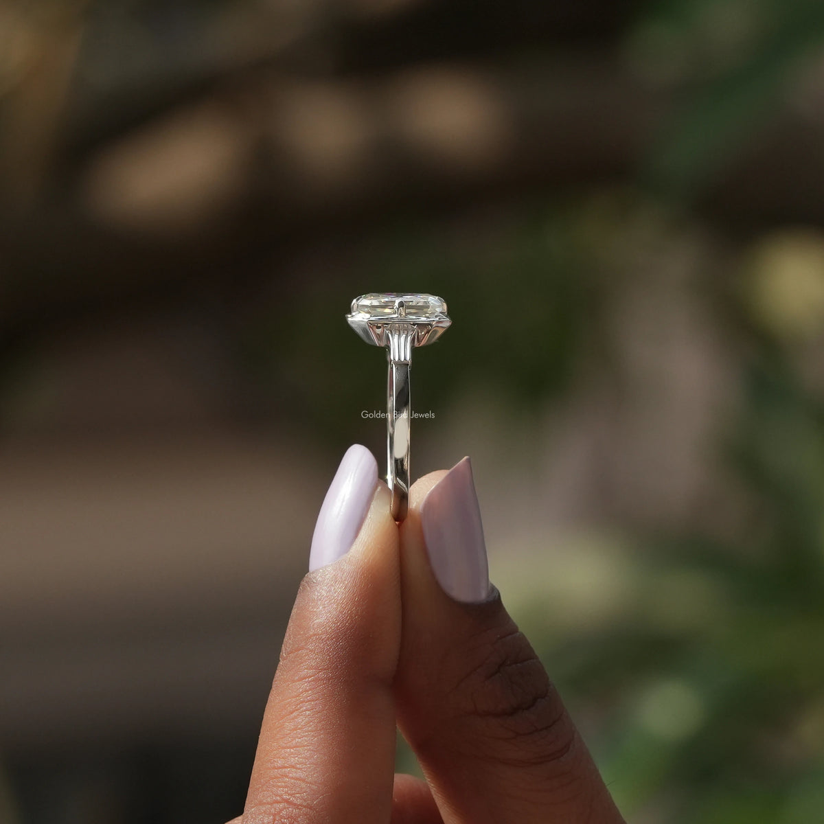 Side View of Radiant Cut Moissanite Solitaire  Ring In two fingers