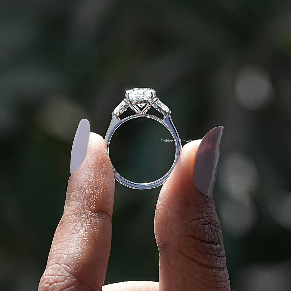 Back View of Oval And Pear Cut Moissanite Engagement Ring In two fingers