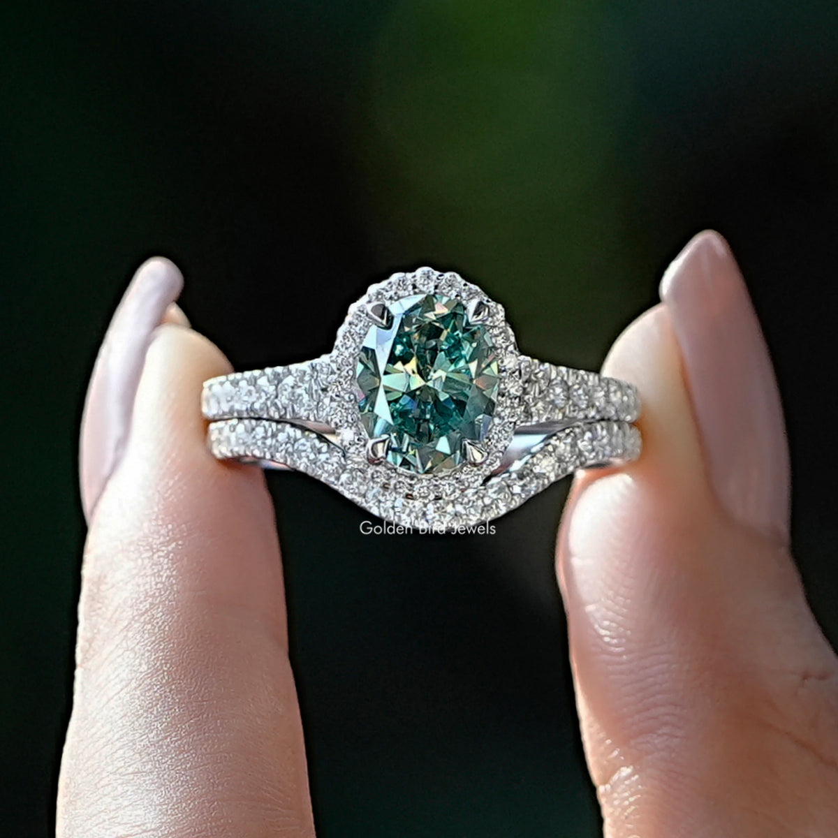 Fron View of A Oval And Round Cut Moissanite Bridal Ring Set in Two Fingers