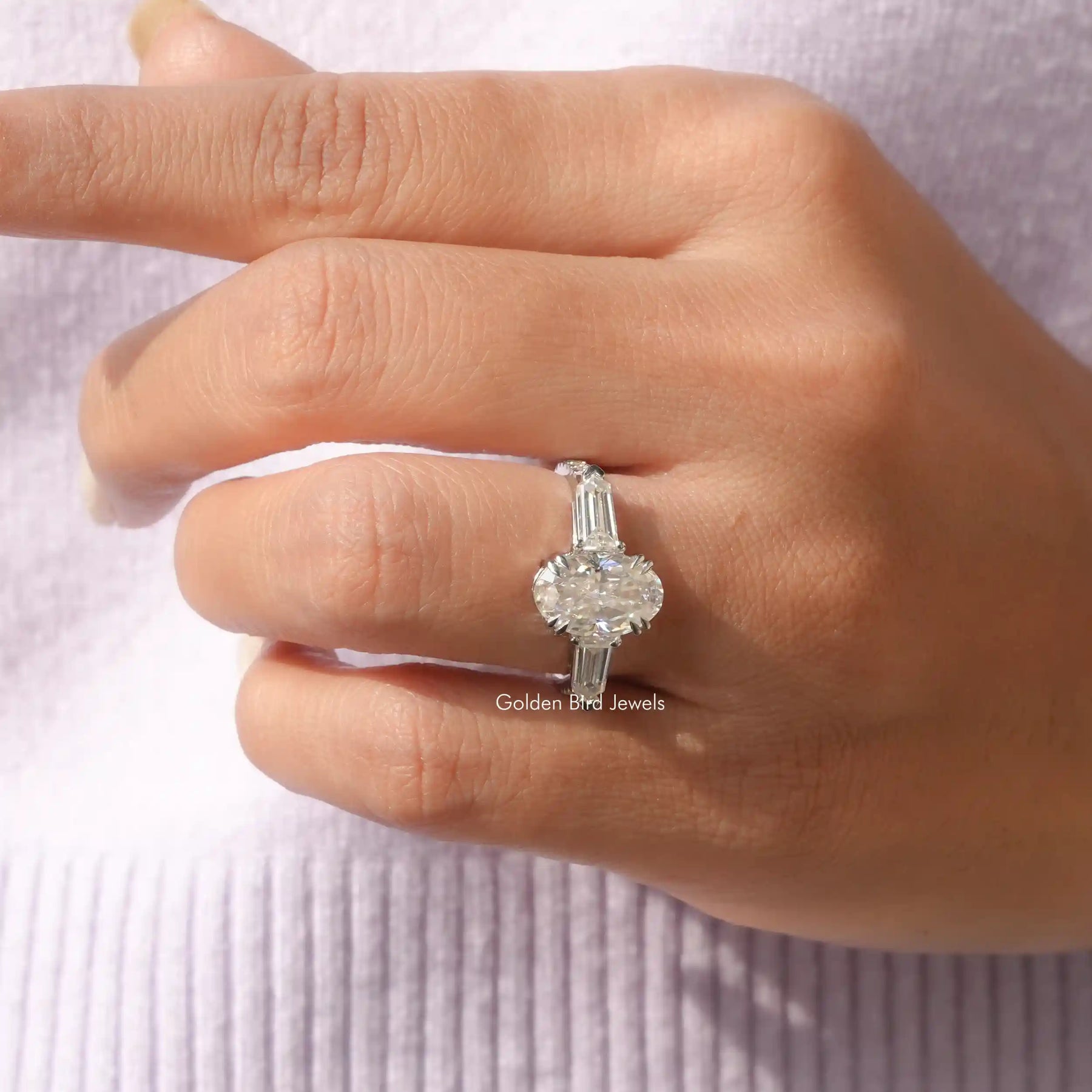 [In finger front view of crushed ice oval cut three stone ring]-[Golden Bird Jewels]