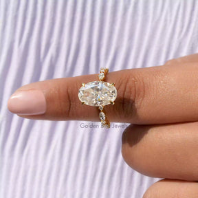 [In finger front view of oval cut accent stone moissanite wedding band]-[Golden Bird Jewels]