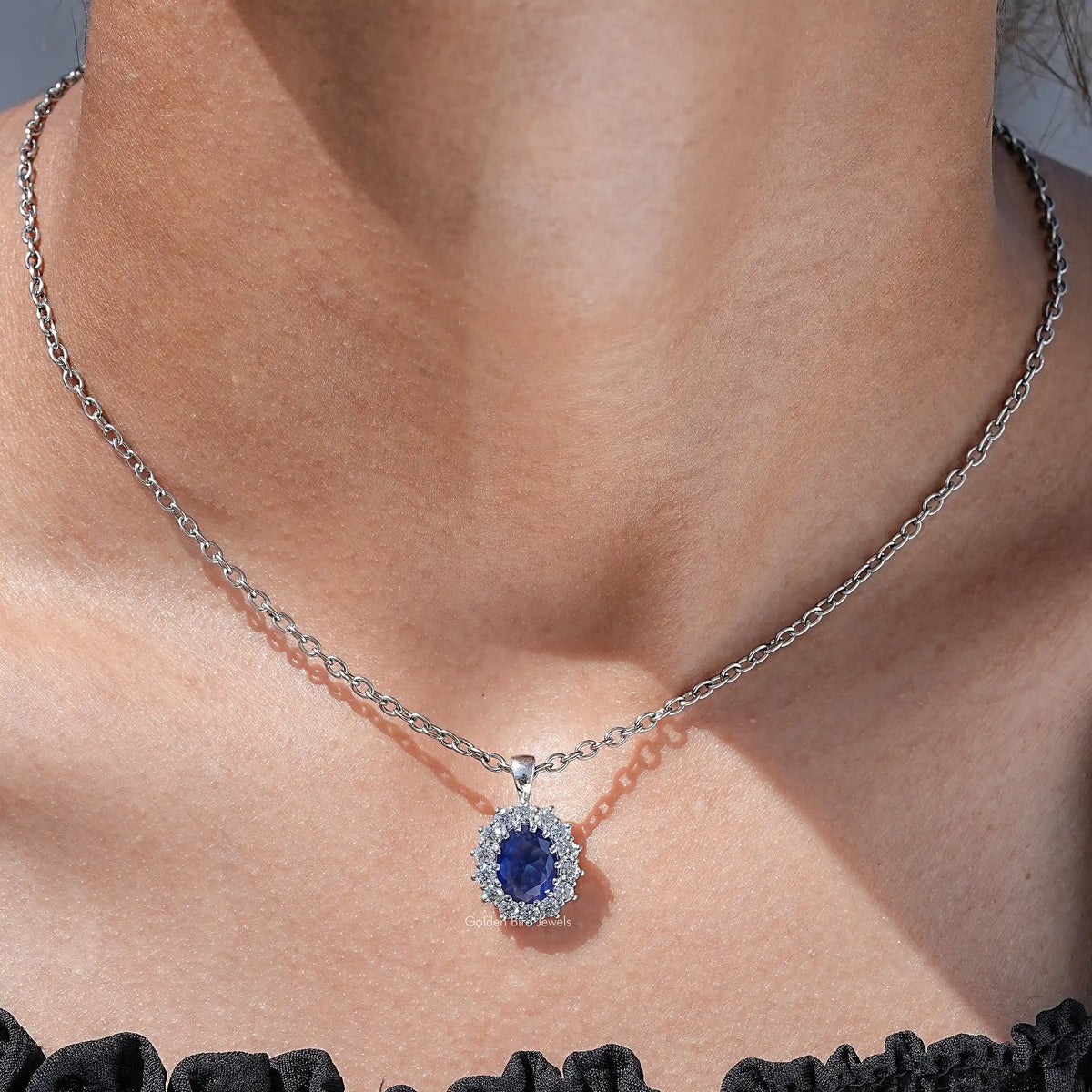 View of lab grown gemestone oval cut halo pendant 