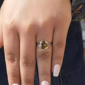 [In finger front view of brown oval cut moissanite engagement ring set in bezel setting]-[Golden Bird Jewels]