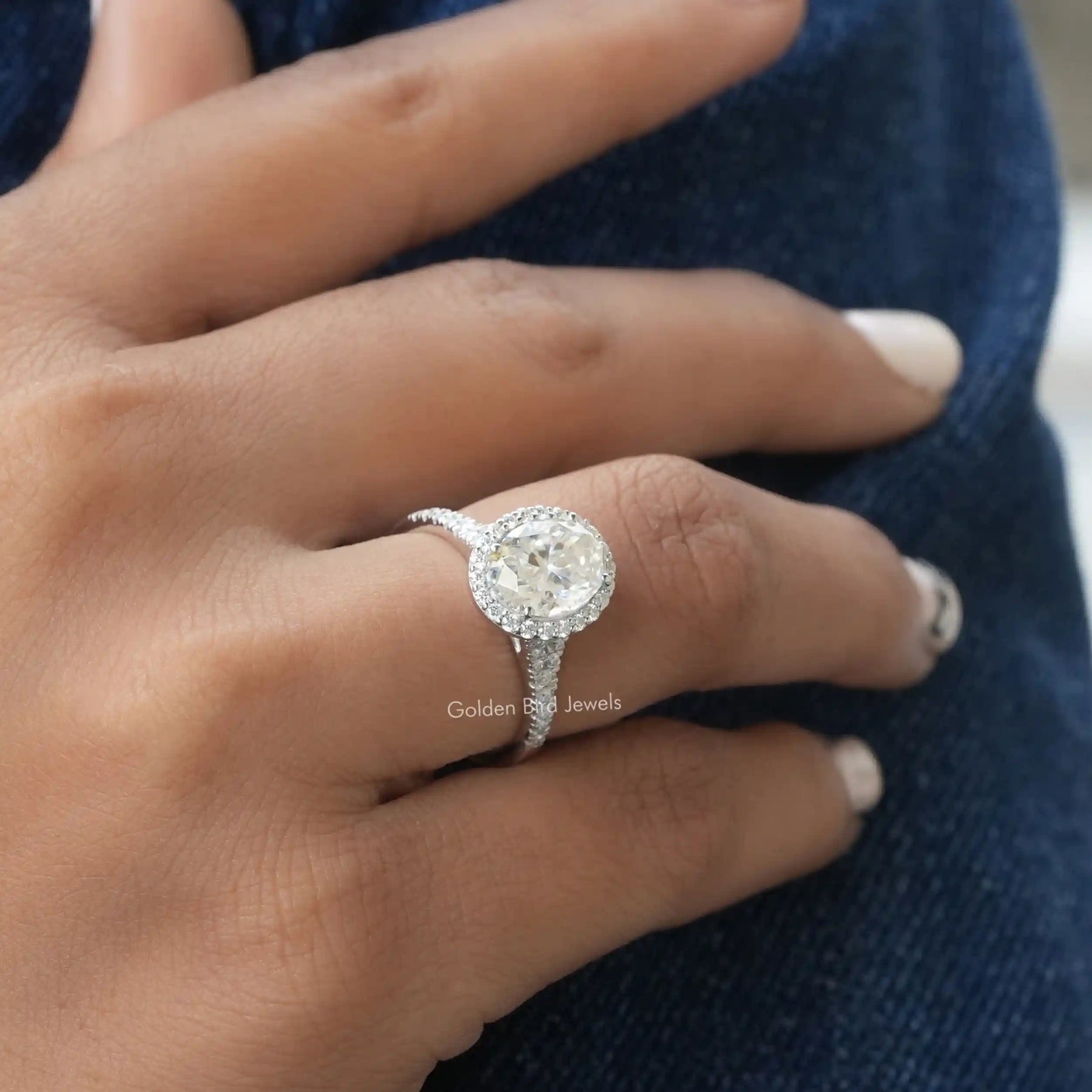 [In finger front view of oval cut moissanite engagement ring made of vvs clarity]-[Golden Bird Jewels]