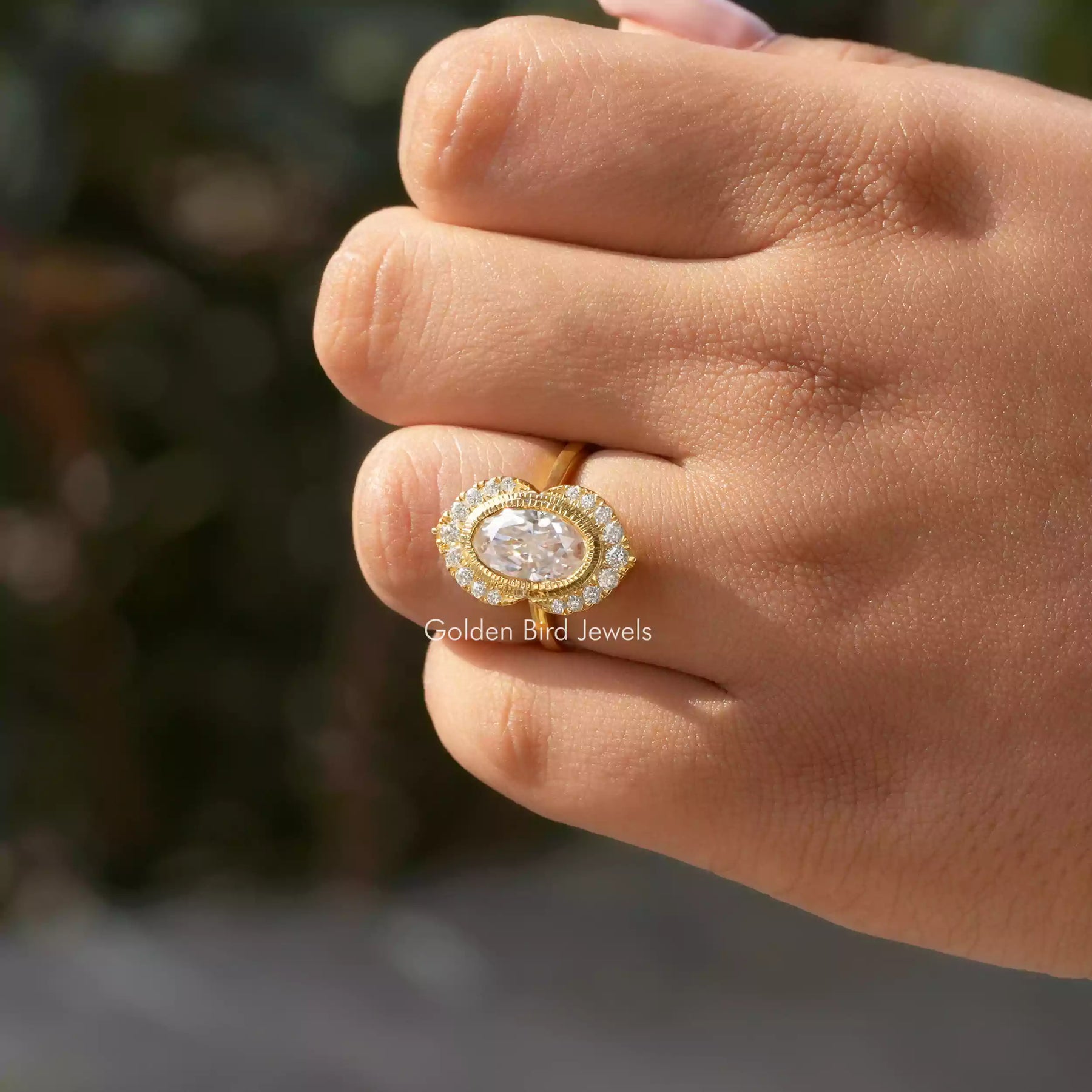 [In finger view of oval halo engagement ring]-[Golden Bird Jewels]