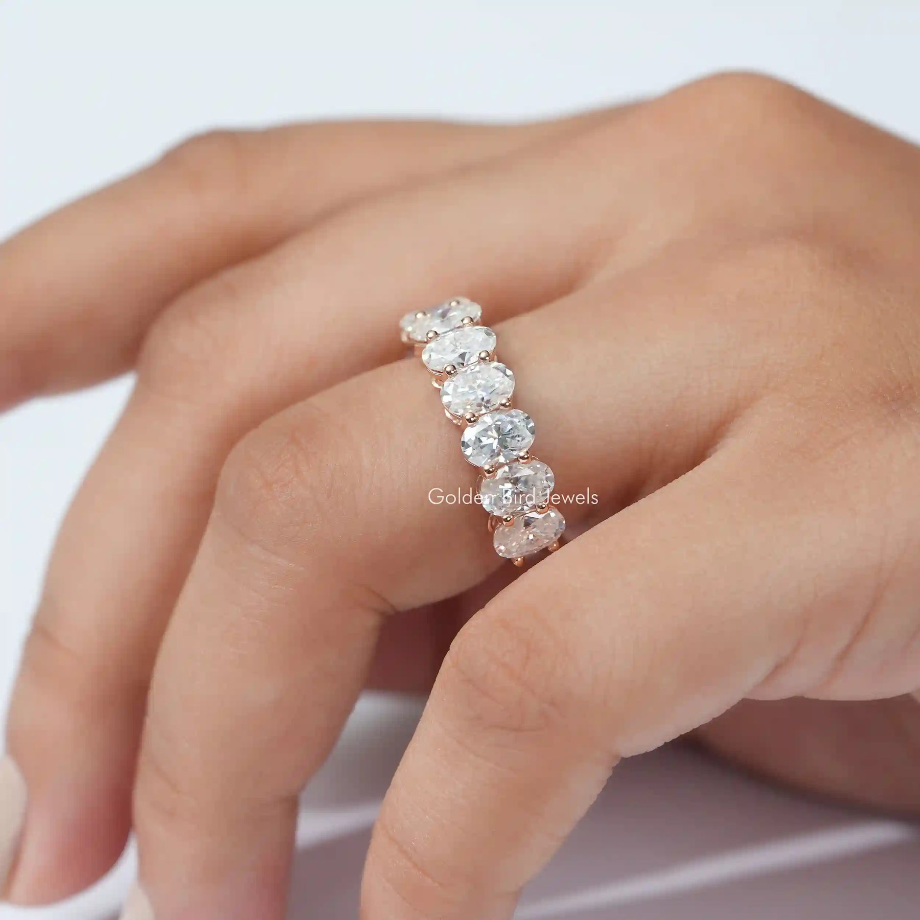 [This moissanite eternity bridal eternity band crafted with oval cut stones]