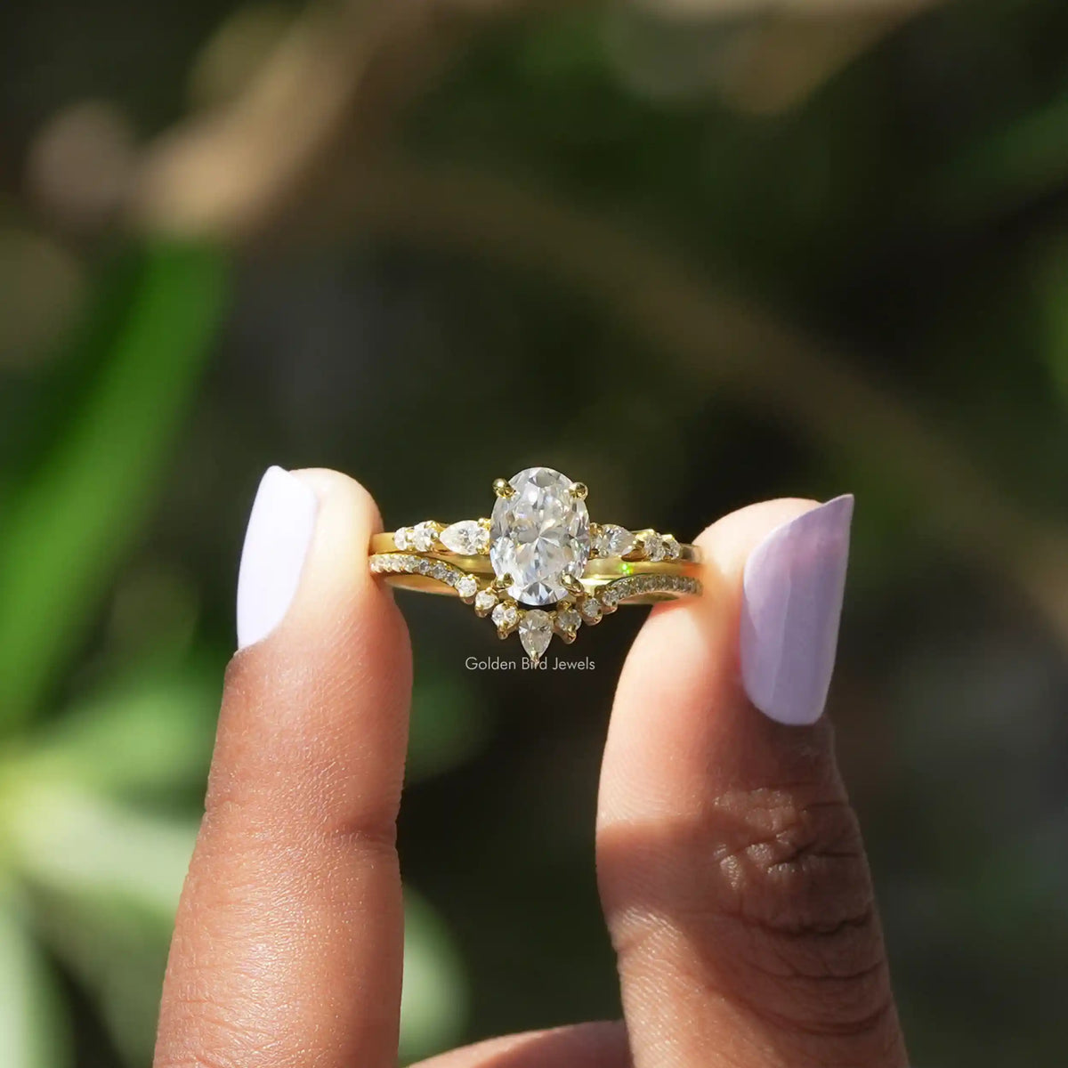 Two fingers holding the Oval Cut Accent Stone Ring