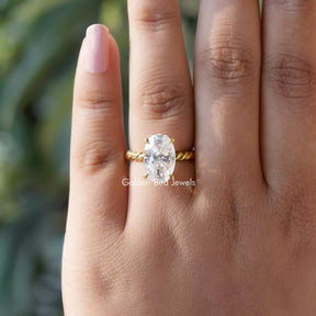 [In finger front view of oval cut moissanite ring made of four prongs]-[Golden Bird Jewels]