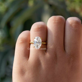 [In finger front view of oval cut moissanite solitaire engagement ring]-[Golden Bird Jewels]