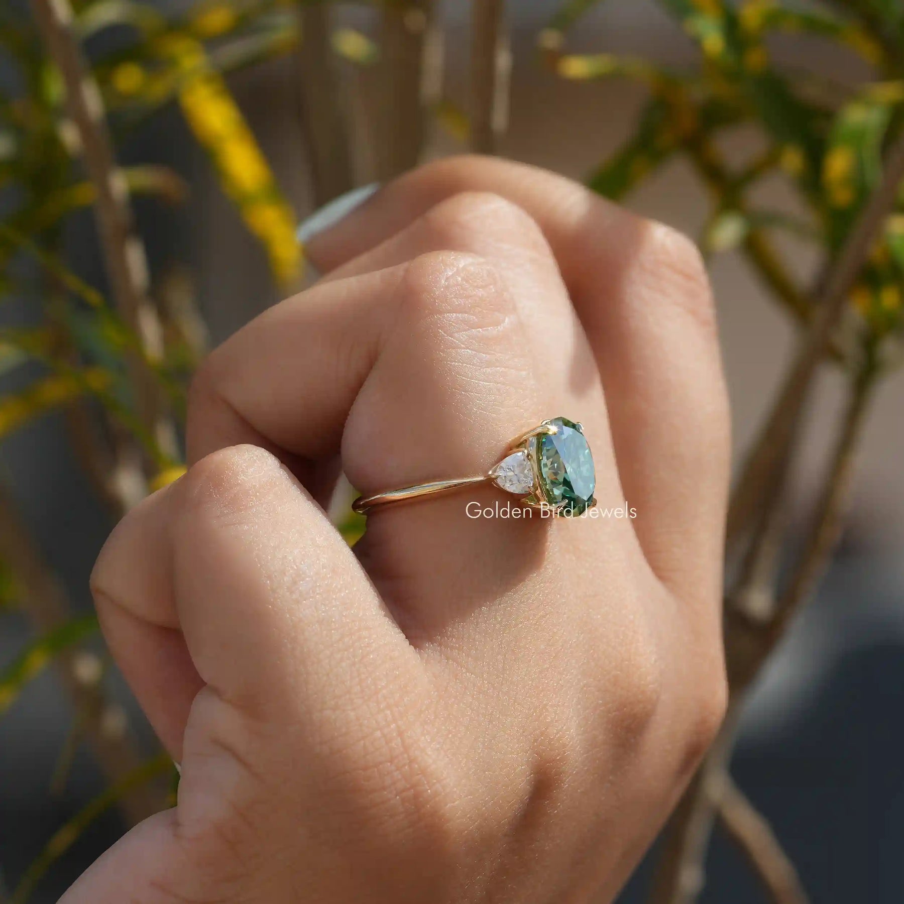 [In finger side view of three stone moissanite ring set in prong setting]-[Golden Bird Jewels]