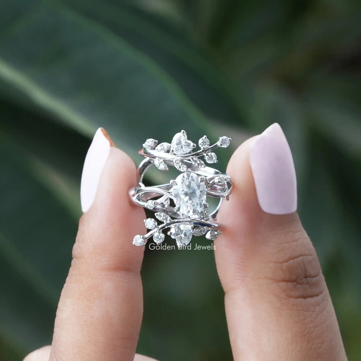 [In two finger front view of oval cut twisted shank moissanite ring]-[Golden Bird Jewels]