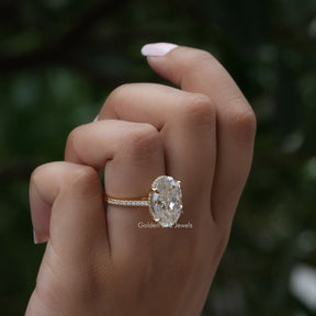Detailed View Of Oval Cut Hidden Halo Ring In Yellow Gold
