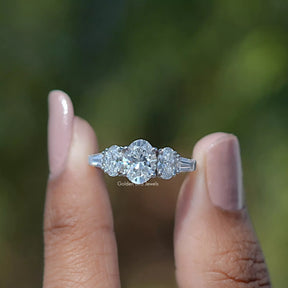 Front View of Oval Cut Lab Grown Diamond Five Stone Engagement Ring In two Fingers