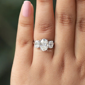 View of Oval Cut Moissanite Three Stone Engagement Ring In Yellow Gold